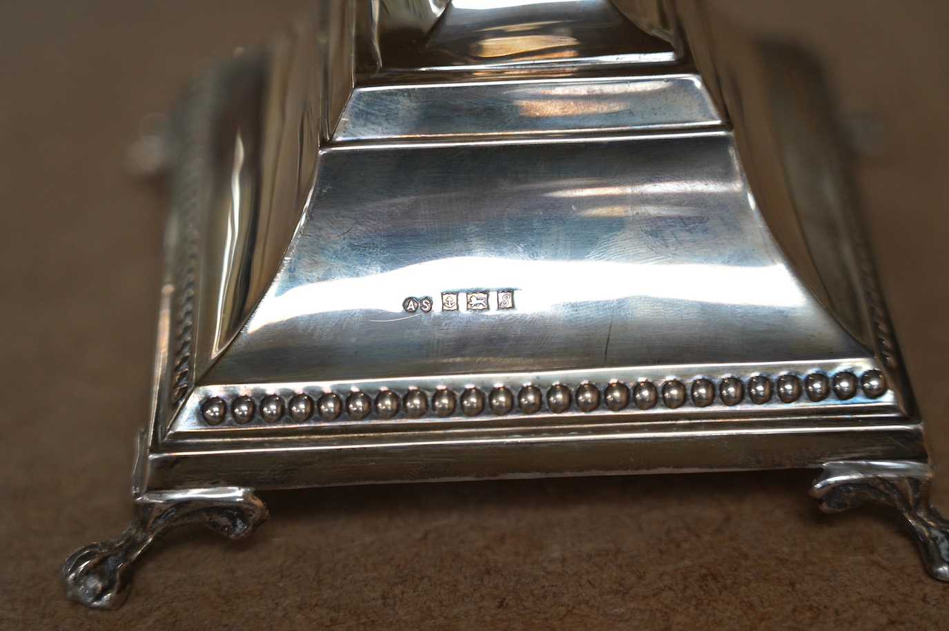 A modern silver Hanukkah Menorah, on a square base with four claw and ball feet, by Alexander Smith, Birmingham, 1967, height 27.6cm, weighted. Condition - fair to good